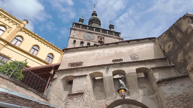 Low angle view of Sighisoara Clock Tower and medieval architecture in Transylvania Romania