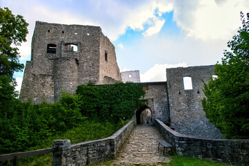 The ruins of the old stone Hukvaldy Castle in the Czech Republic. A view of the fortifications and the castle entrance with its bridge. © Jan