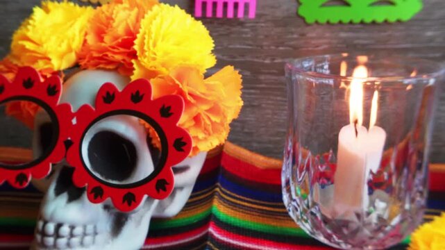 Sugar skull with marigolds and candle for dia de los muertos altar
