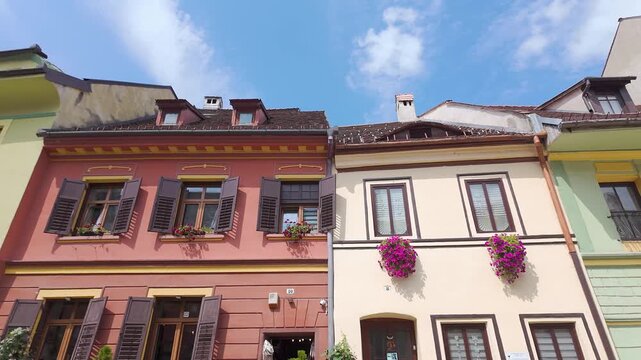 Colorful historic house facades with wooden shutters in old town Sighisoara Transylvania Romania