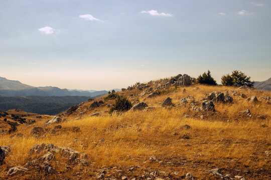 Dry Mountain Landscape with Golden Grass and Rocky Hills Under Dramatic Sky, Bjelasnica, Bosnia and Herzegovina