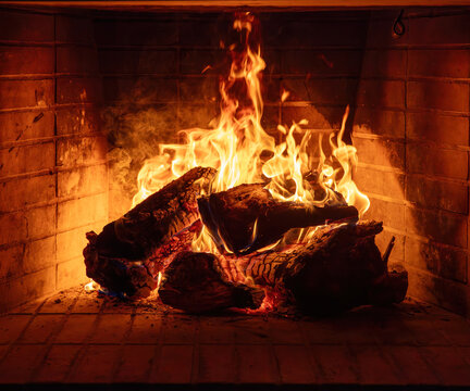 Fireplace burning wood logs. Cozy warm home in winter, Christmas time bonfire. Fire flames