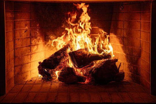 Fireplace burning wood logs. Cozy warm home in winter, Christmas time bonfire. Fire flames