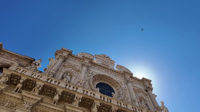4k video of the intricate stone rose window on the facade of the basilica di santa croce in lecce, apulia. famous example of apulian baroque architecture crafted in local lecce stone, pietra leccese