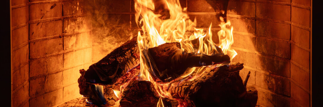 Fireplace burning wood logs. Cozy warm home in winter, Christmas time bonfire. Fire flames