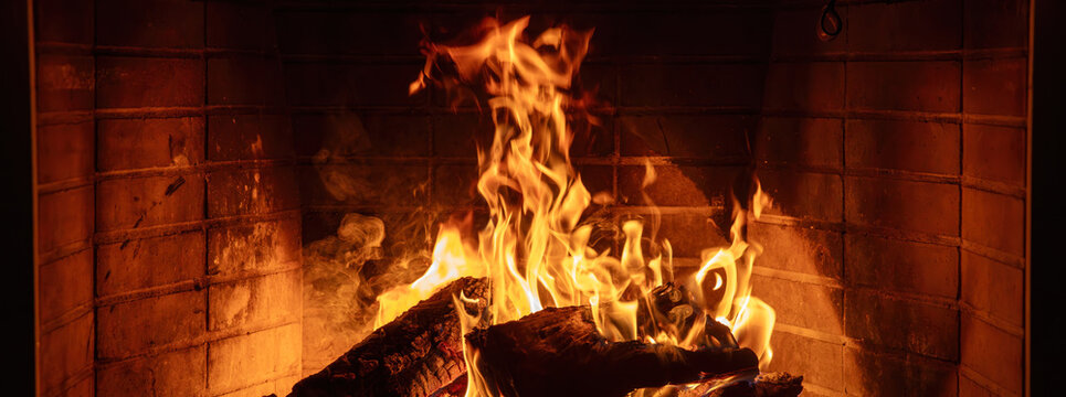 Fireplace burning wood logs. Cozy warm home in winter, Christmas time bonfire. Fire flames