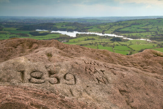 Weathered stone outcrop of Hen Cloud at The Roaches showing a carved 1859 inscription