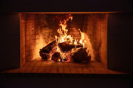 Fireplace burning wood logs. Cozy warm home in winter, Christmas time bonfire. Fire flames