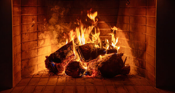 Fireplace burning wood logs. Cozy warm home in winter, Christmas time bonfire. Fire flames