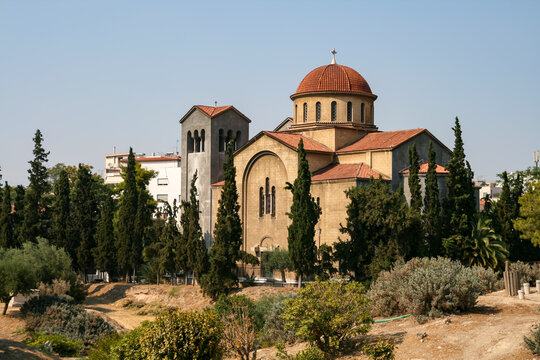 Ekklisia Agia Triada historic church building surrounded by trees in Athens