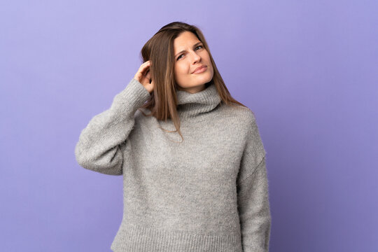 Young Slovak woman isolated on purple background having doubts