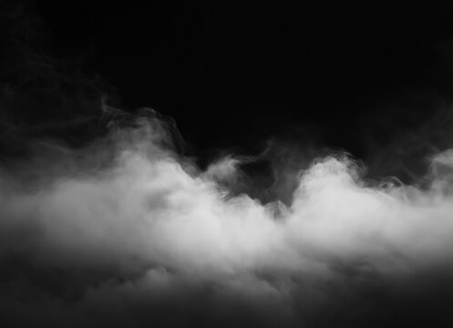 Dense white smoke or fog rolling across the bottom of a dark black background, isolated effect