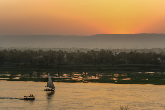 Sunset over the River Nile with a traditional sailing boat in Luxor Egypt