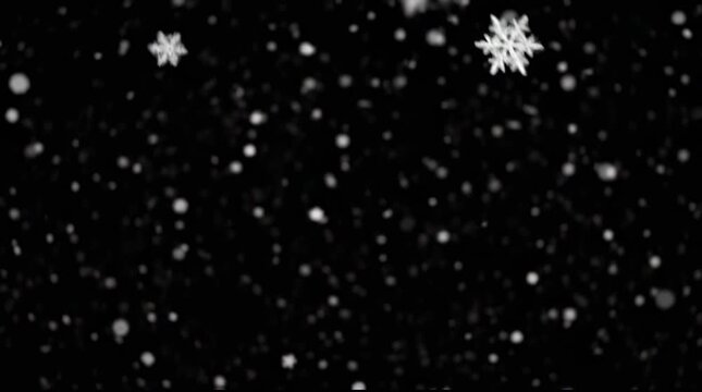 Falling snowflakes against black background