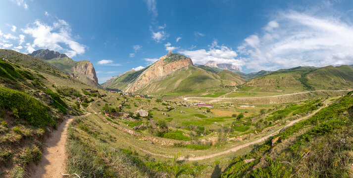 The green slopes and rocky summits of the Caucasus Mountains in Chegem Gorge