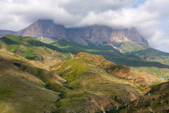 The green slopes and rocky summits of the Caucasus Mountains in Chegem Gorge