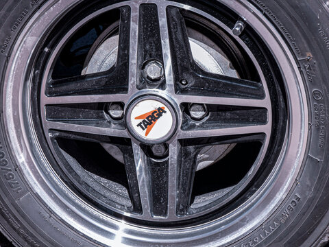 Gandia, Spain - September 19, 2026. Close up macro shot of Targa center cap on vintage black and silver alloy wheel
