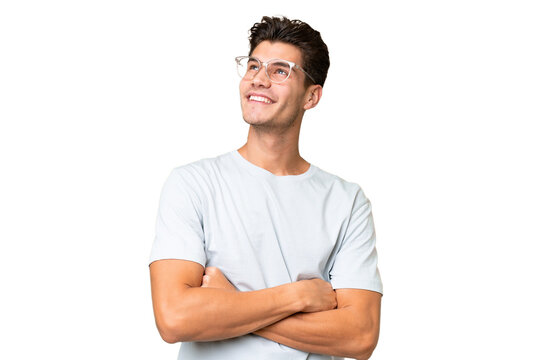 Young caucasian handsome man over isolated background looking up while smiling