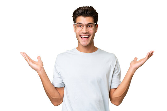 Young caucasian handsome man over isolated background with shocked facial expression