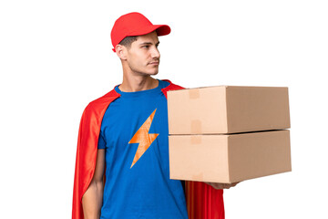 Super Hero delivery man over isolated background looking to the side © luismolinero