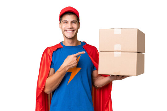 Super Hero delivery man over isolated background pointing to the side to present a product