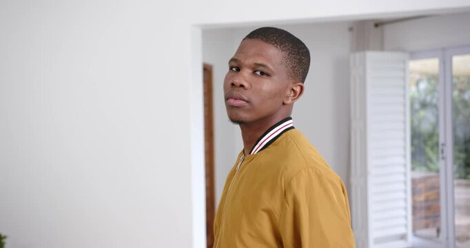 High speed photography for dynamic scenes, looking away, man in yellow jacket standing indoors, appe