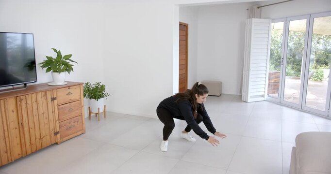 High speed photography for dynamic scenes, woman in black hoodie standing in living room, gesturing