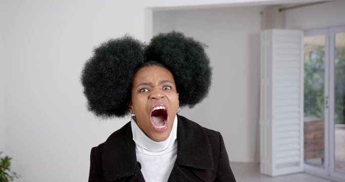 High speed photography for dynamic scenes, woman in black coat shouting with wide open mouth, expres