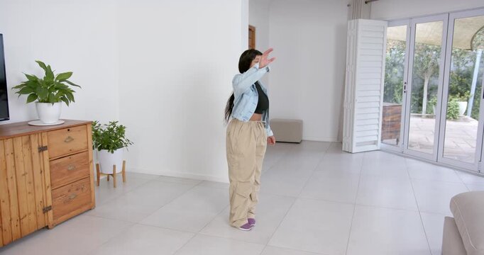 High speed photography for dynamic scenes, woman in casual outfit standing in living room, looking t