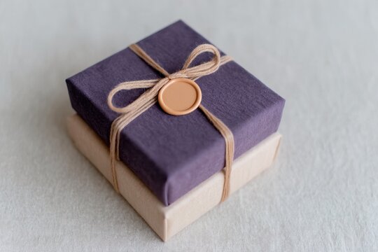 Gift box tied with string on a light surface