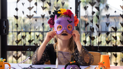 Naklejka na ściany i meble Girl wearing handmade Halloween mask at craft party