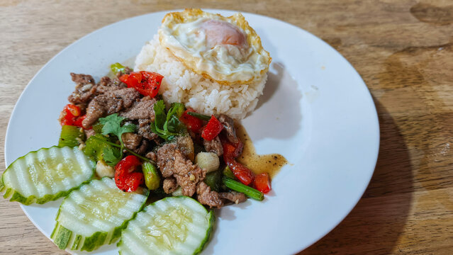 Stir Fried Beef with Bell Peppers and Fried Egg Served with Steamed Rice