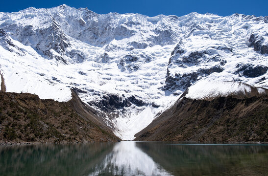 Snow capped mountain reflecting in glacier Humantay lake. Vilcabamba mountain Andes Cusco Peru