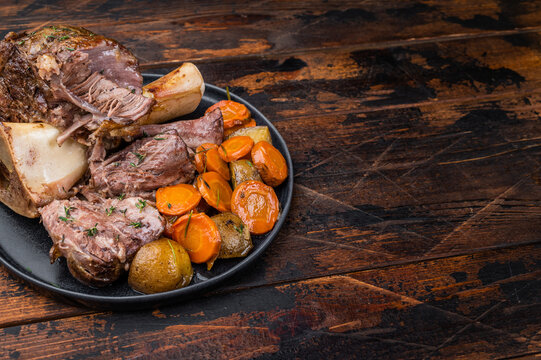 Classic italian veal shank osso buco plated with marrow bone and vegetables rustic food styling
