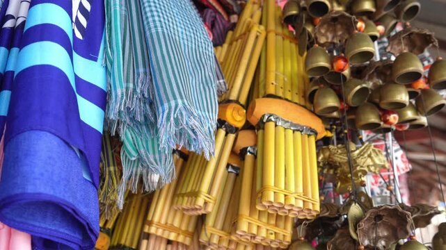 Traditional Thai souvenir market selling bamboo khaen musical instruments and brass wind chimes in Thailand