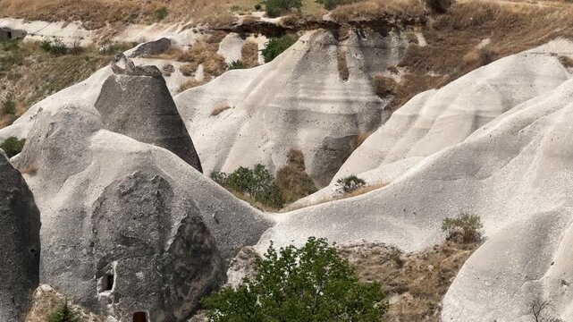 Aerial view of Cappadocia, Turkey, with pale volcanic rock formations and cave dwellings. Distinctive geological landscape for travel and tourism content.
