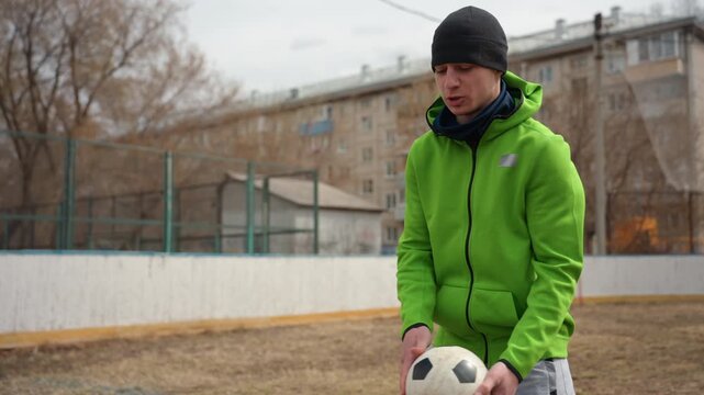 confident street athlete juggling soccer ball, closeup of urban performer executing freestyle soccer tricks, vibrant street scene capturing skilled individual juggling soccer ball confidently