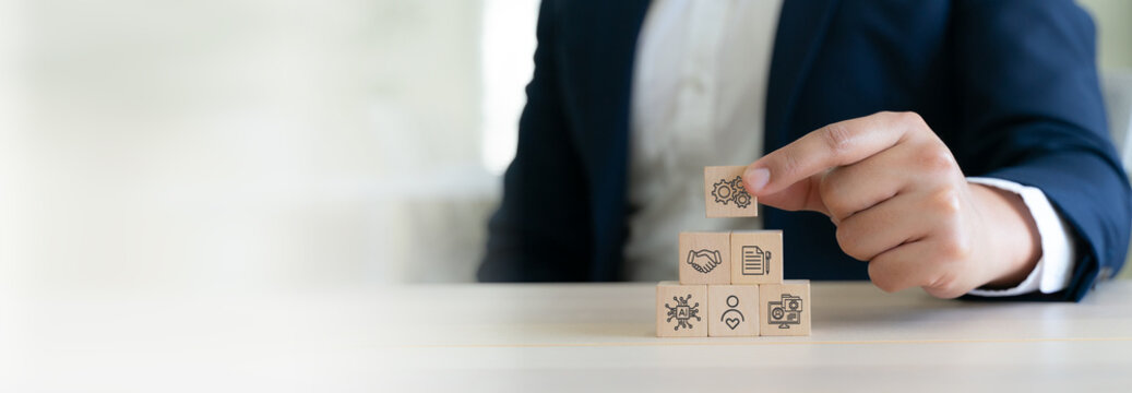 Business Roadmap for Growth. Wooden blocks with AI, customer data, customer relationship management, recurring revenue, partnerships, integrated ecosystem for sustainable business growth.
