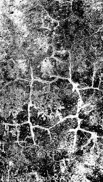 High contrast black and white abstract background with a rough cracked stone or concrete wall texture