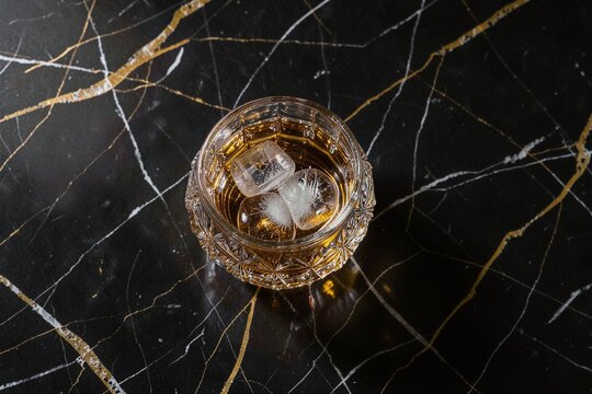 Cut Crystal Whiskey Tumbler with Hand Carved Ice Sphere Flat Lay with