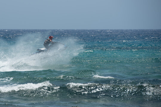 Jet skiing sport on rough waters with splashes and waves