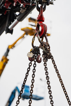 Heavy lifting hook with safety latch, connecting shackle, and suspended steel chains shown on lifting equipment for rental inspection and rigging service