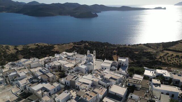 Sunlit Aegean Sea and Church Bell Towers in Plaka Milos