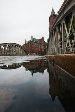 Historic Hamburg architecture reflecting in urban puddle