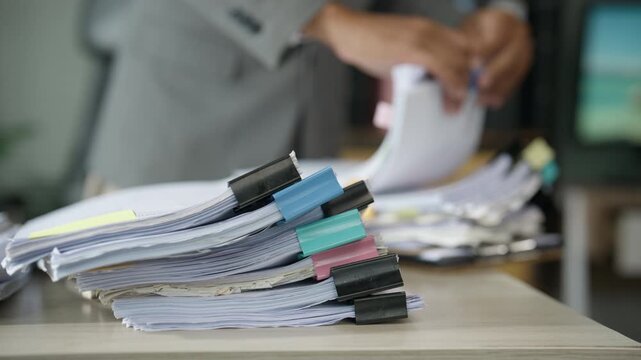 Busy Businessman Managing Heavy Office Paperwork and Documents