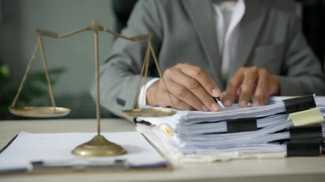 Businessman Reviewing Financial Documents with Calculator at Office Desk