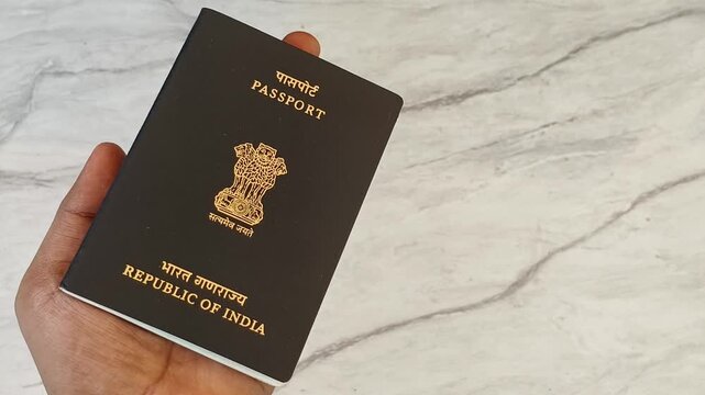 Indian traveller person palm showing general black India passport identity or citizenship document for personal identification information. International tourism or overseas education concept.