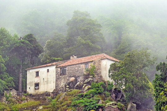 Historic Stone Buildings of the Convent of the Capuchos in Sintra Hidden in Misty Forest