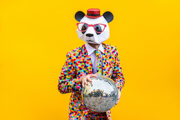 Funny man wearing colorful costume with animal low-poly mask on colored background © oneinchpunch