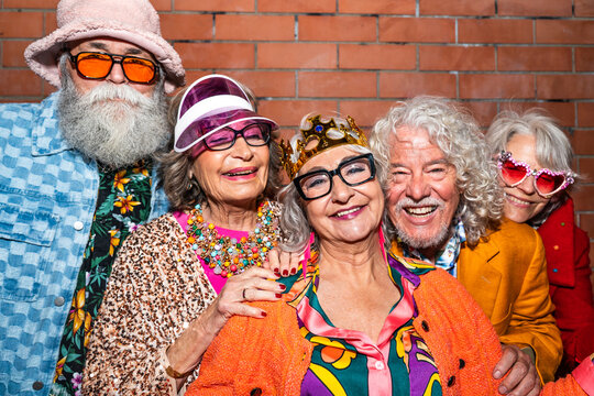 Group of happy senior friends with fancy clothing having party in the night